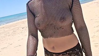 On a public beach, while walking in a transparent blouse, I meet a stranger