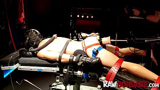 Chained jock lying face down being fisted in his ass