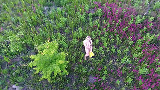 Cutie shows off her body in a flower field