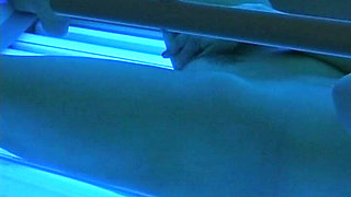 Watch How This German Babe Plays with Her Pussy in Sunbed