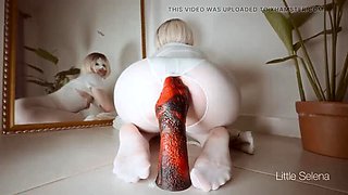 Red Hero Teases Her Tight Ass with a Huge Dildo