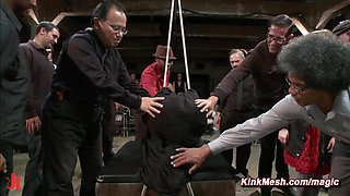 Tied and shrouded in a black sheet