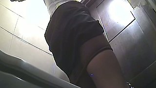 Lovely brunette in long black skirt and sexy black stockings in the toilet room