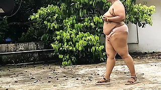 A Full-figured Woman in a White Skirt and Pink Top Strips Down and Walks Nude Outside