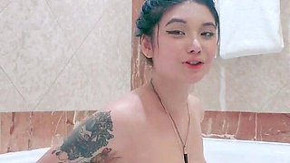 Busty babe playing with her big boobs